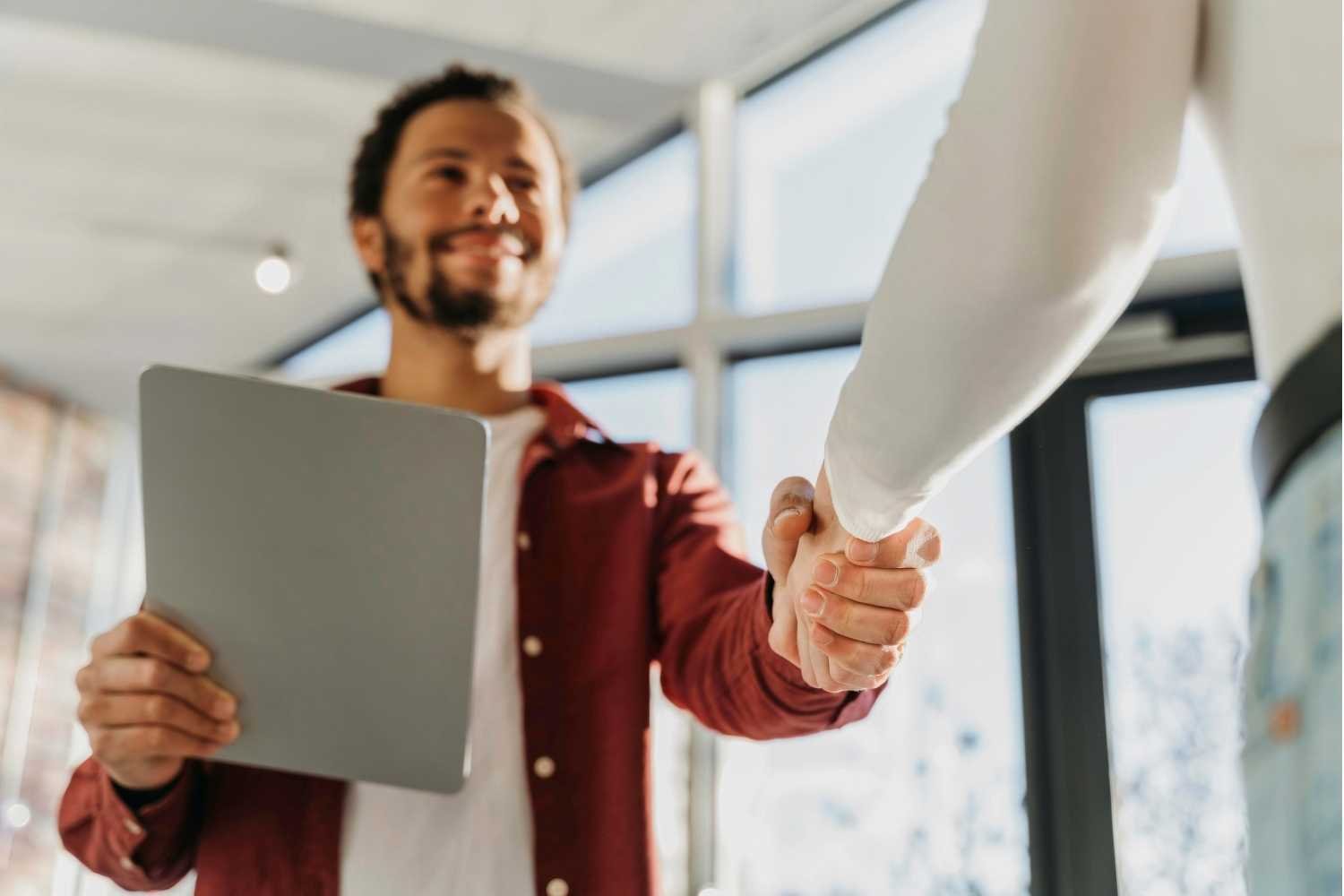 Business Handshake in Modern Office Setting