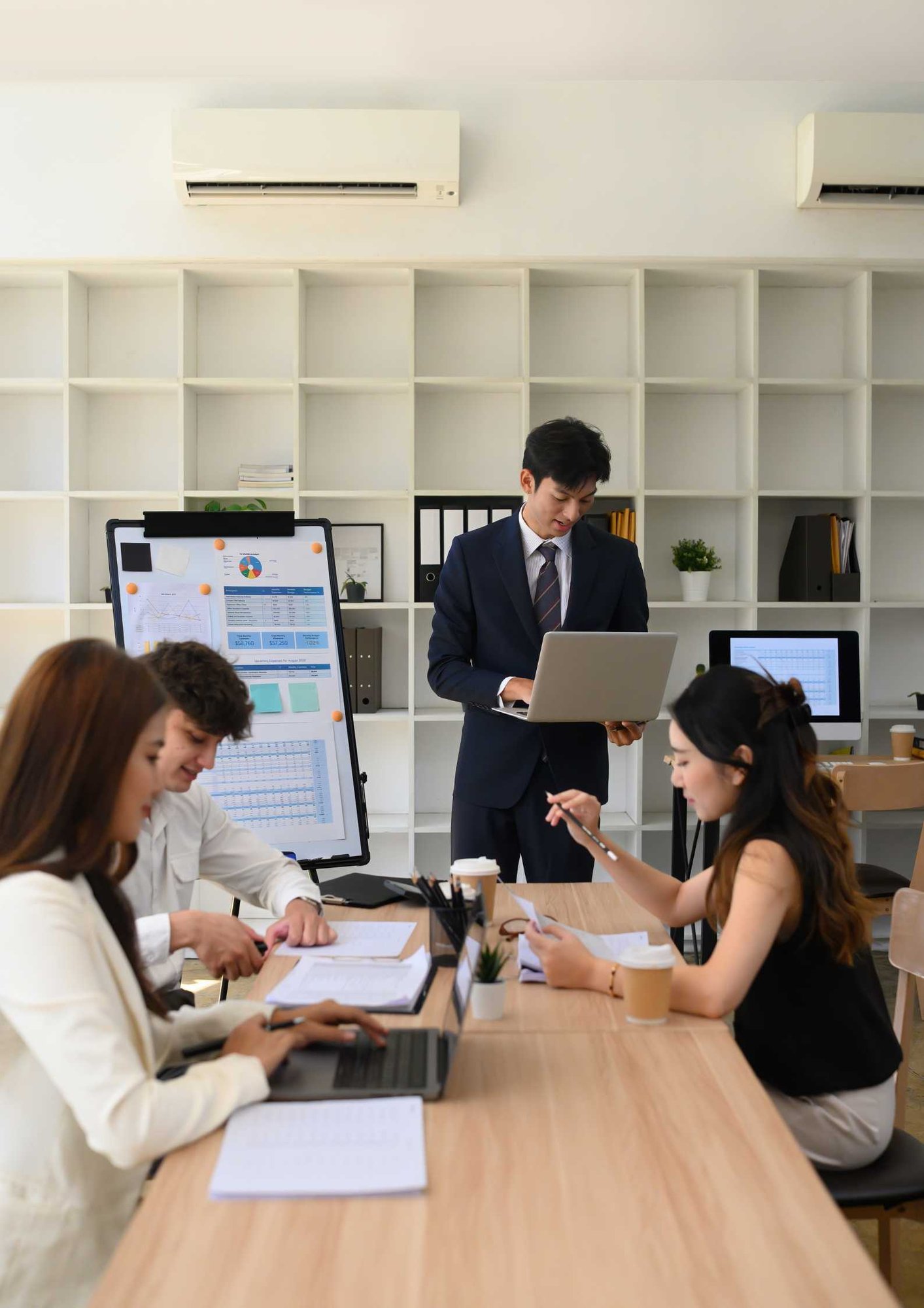 Diverse Business Team Collaborating During Office Presentation, Vertical image