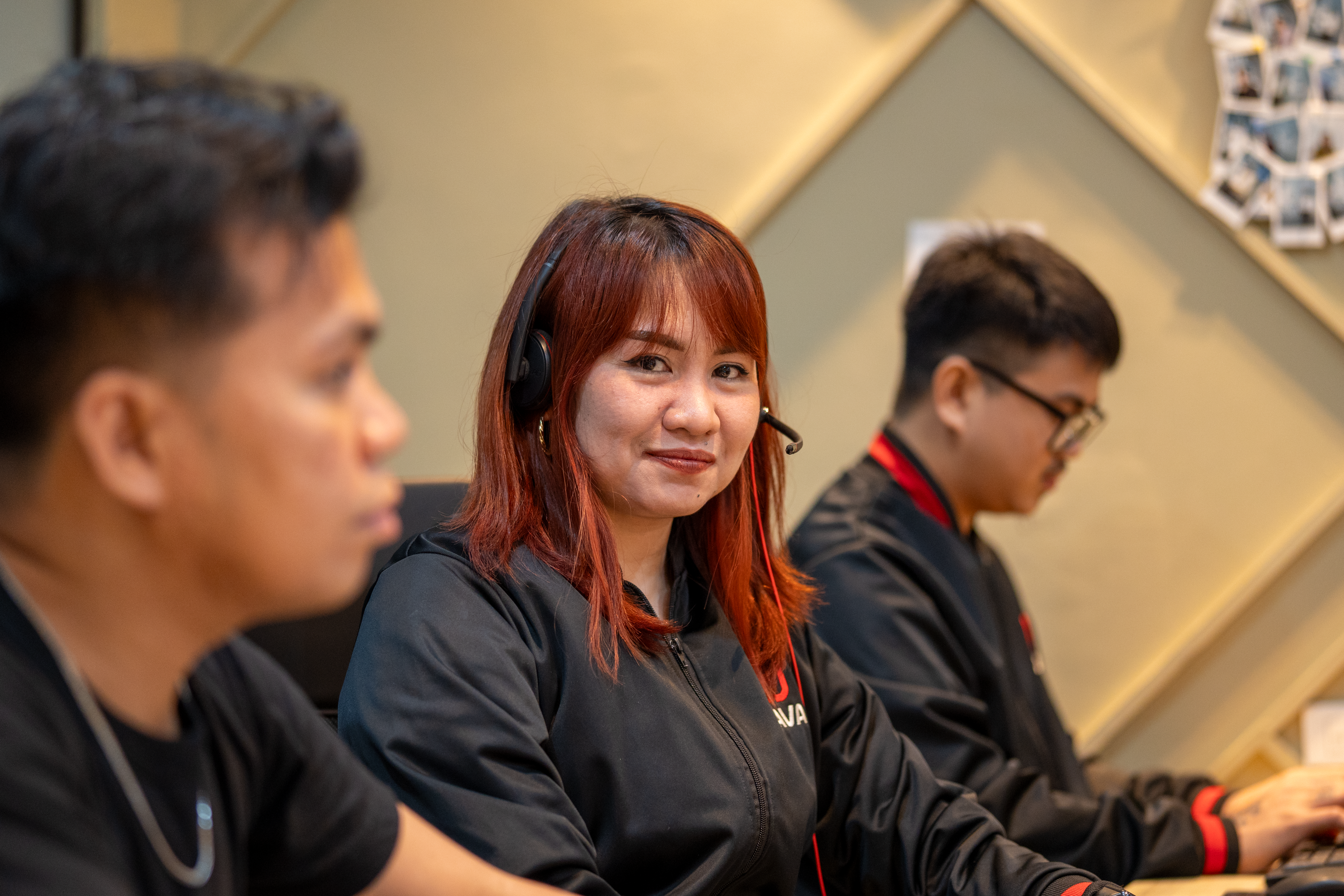 A smiling lava virtual assistant starring at the camera while sitting next to two more lava virtual assistants