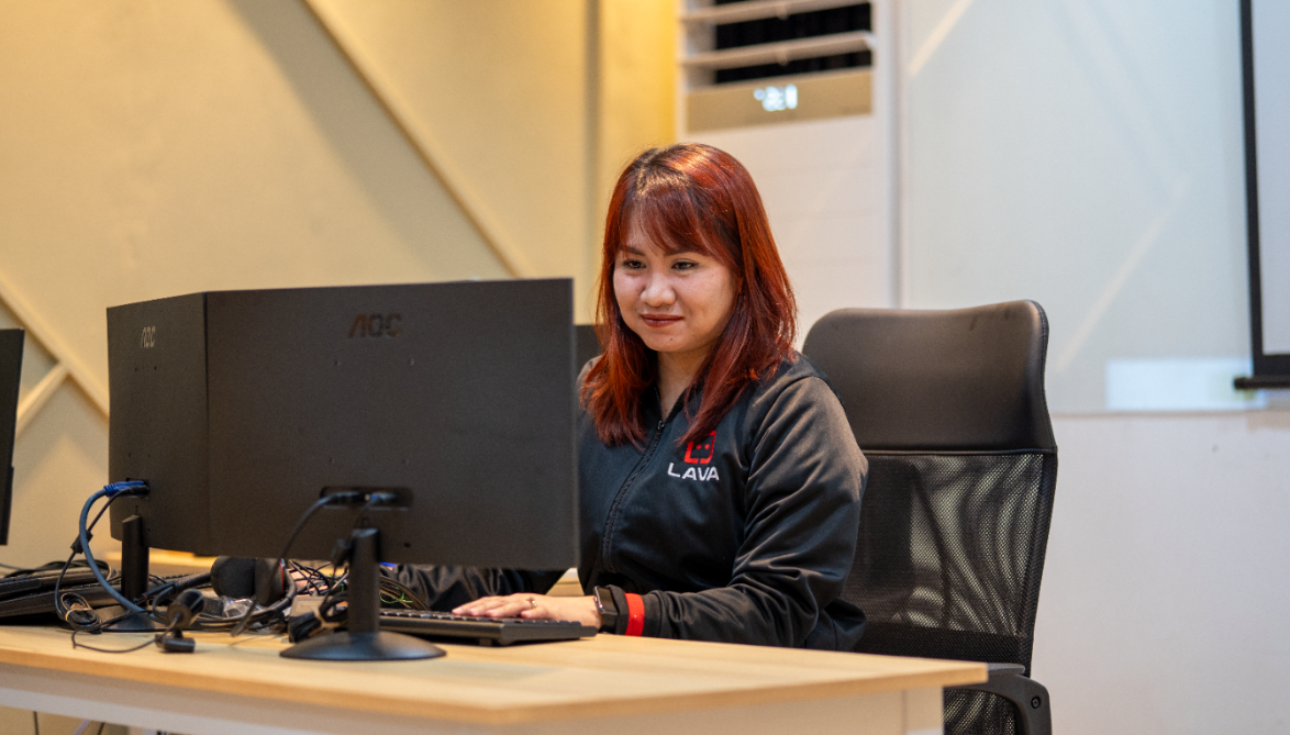 Lava automations Virtual assistant looking at the computer screen while smiling