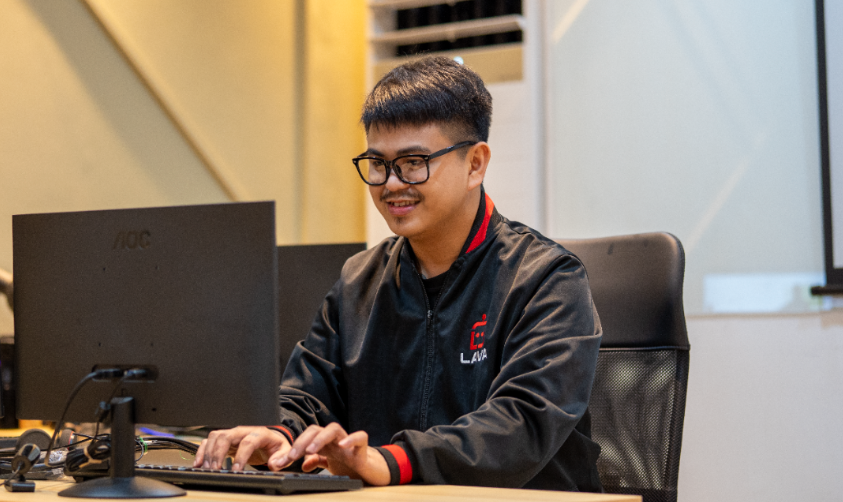LAVA Automations Virtual Assistant Looking at the Computer while smiling