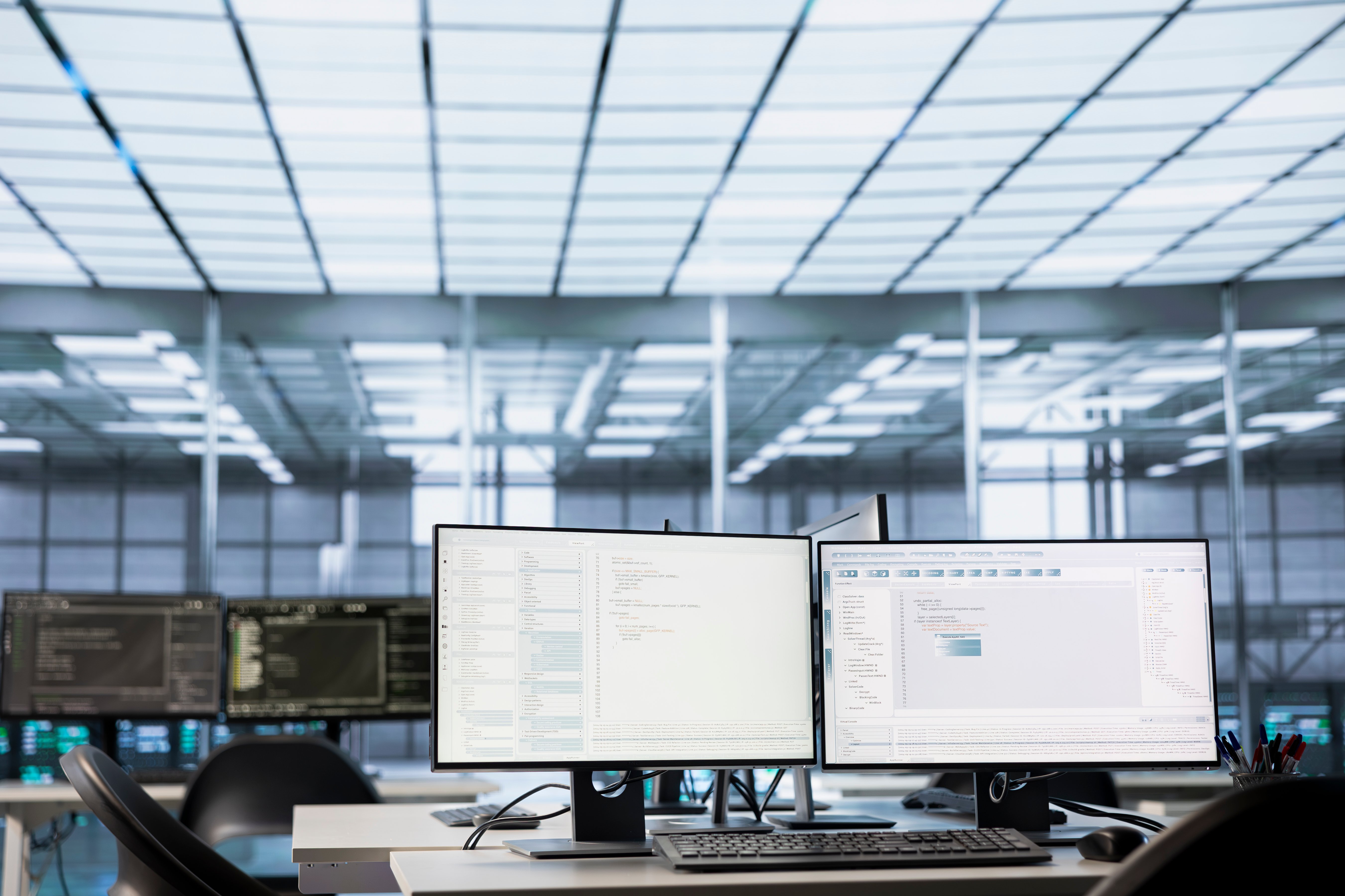 Two monitors showing A.I. Codes inside an Information Technology Office 