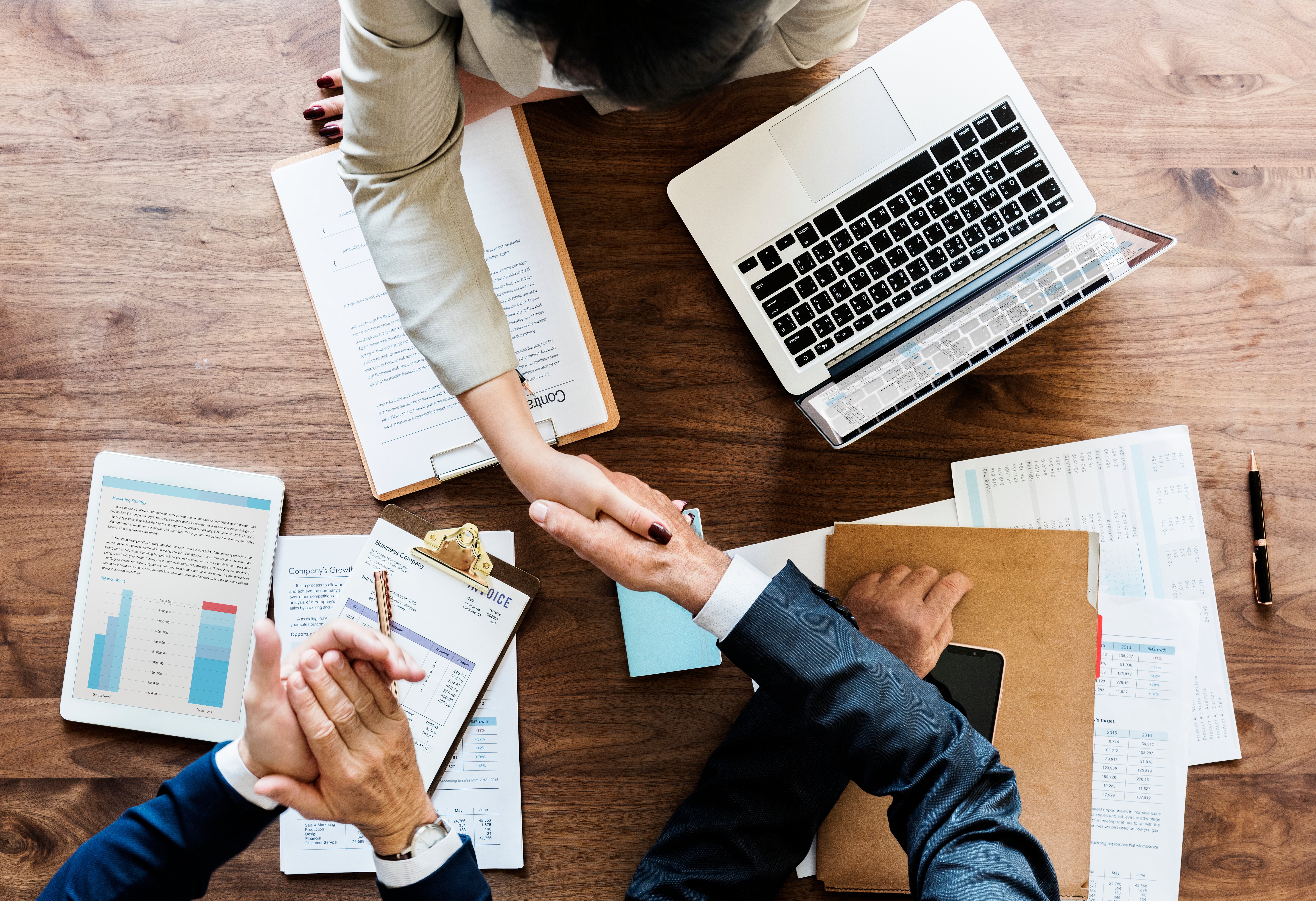 Overhead view of two business professionals shaking hands