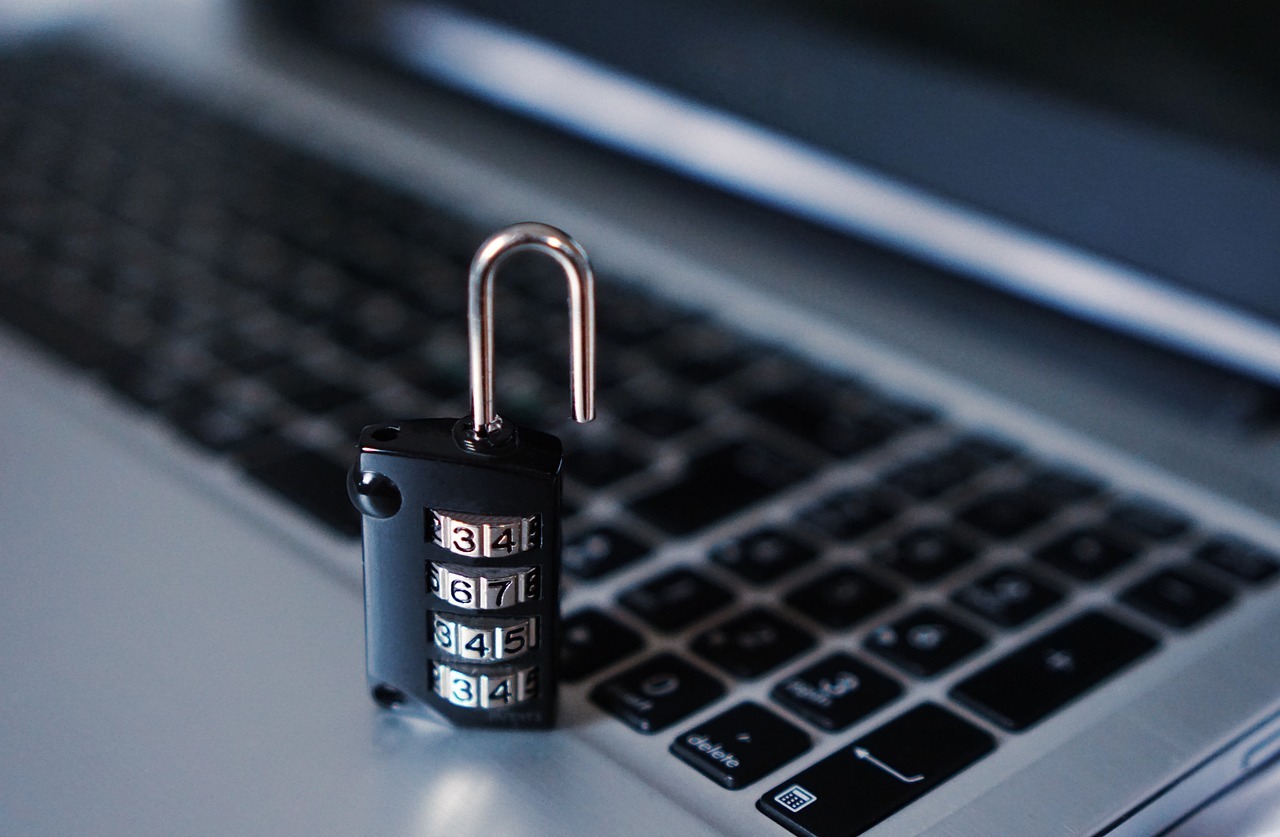 Combination lock on laptop keyboard representing cybersecurity and data protection
