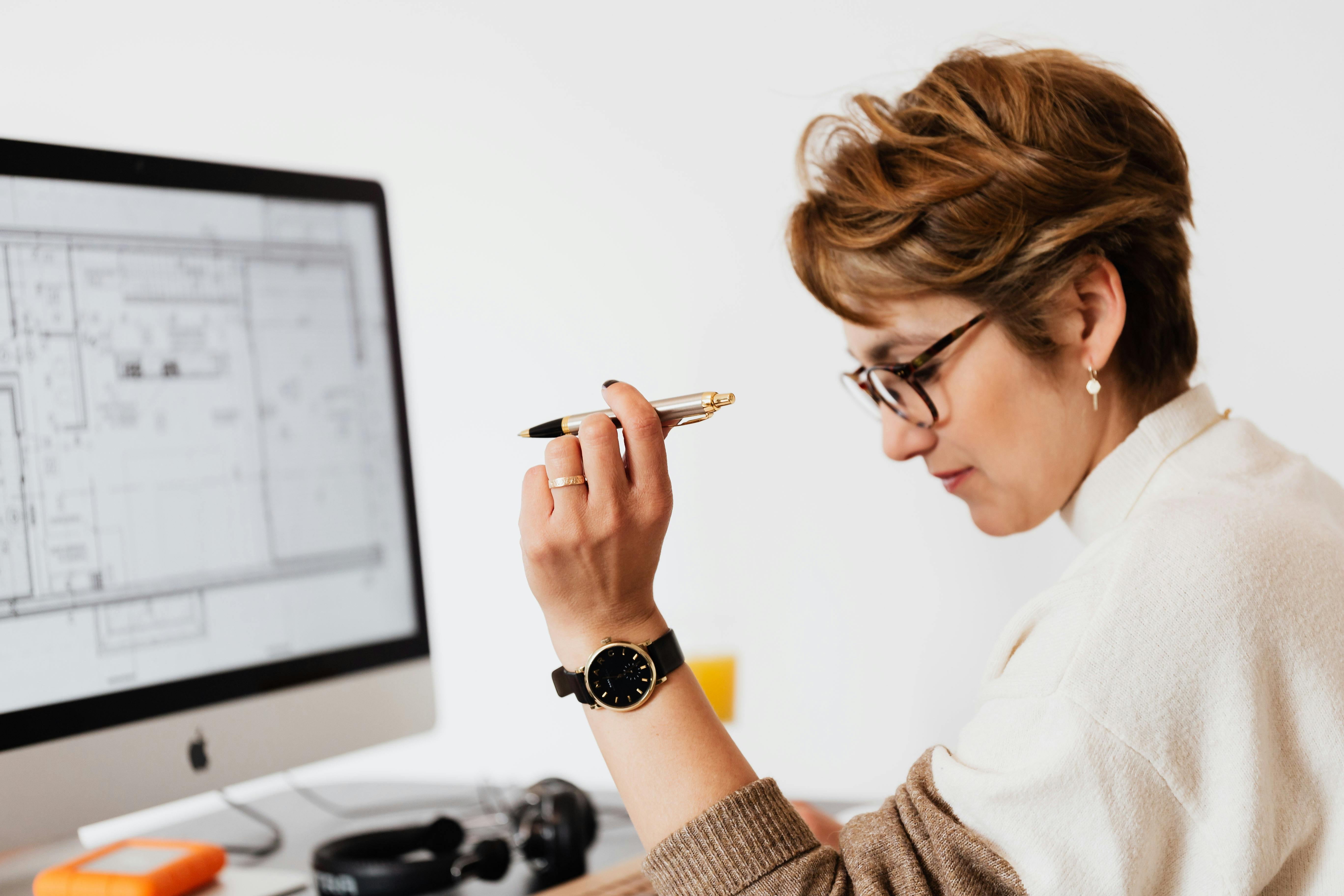 Professional reviewing documents on a computer screen