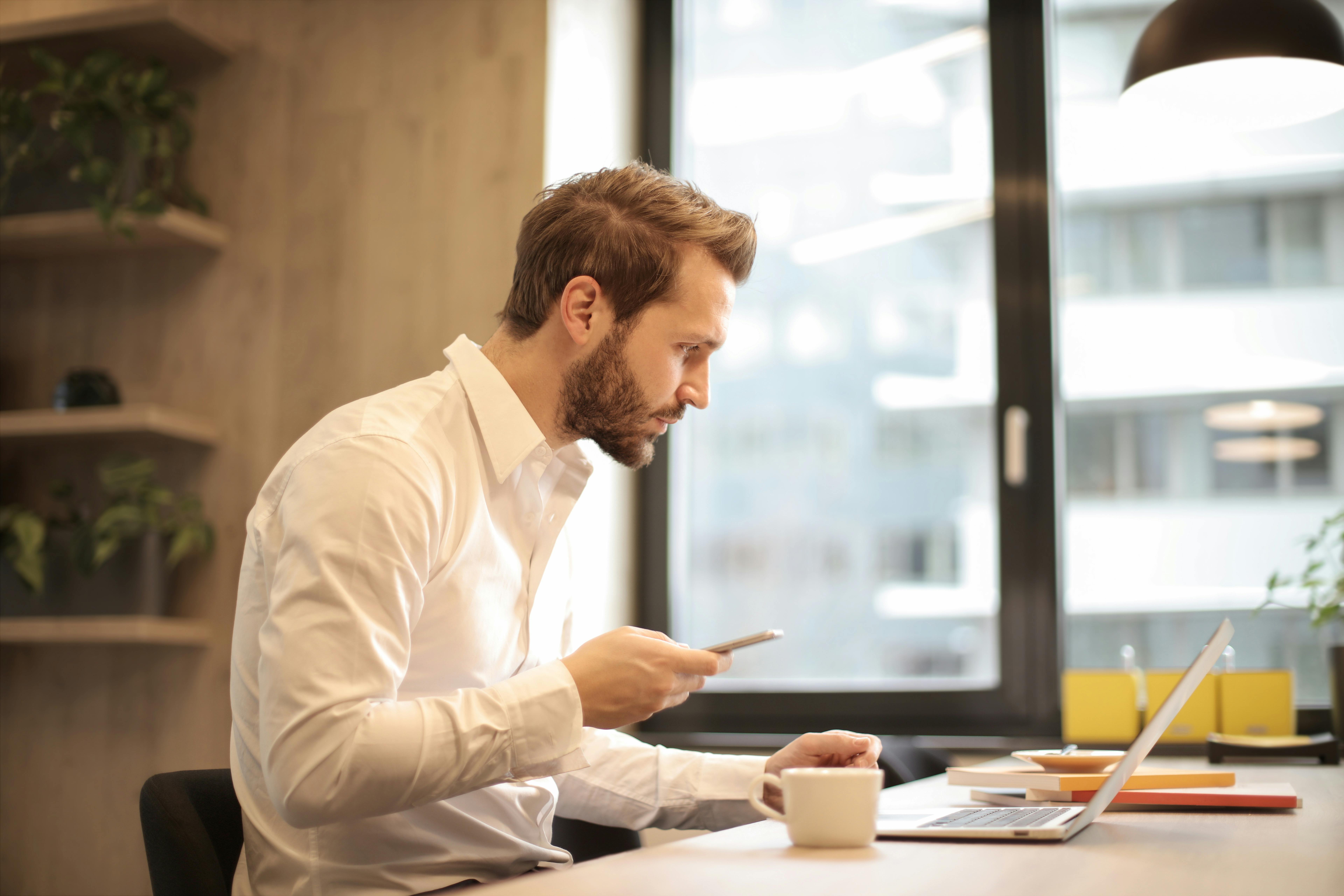 Professional man working on laptop while holding smartphone at office deskFind the best virtual assistant company for insurance. Compare providers side by side and see how training and compliance safeguard your agency.