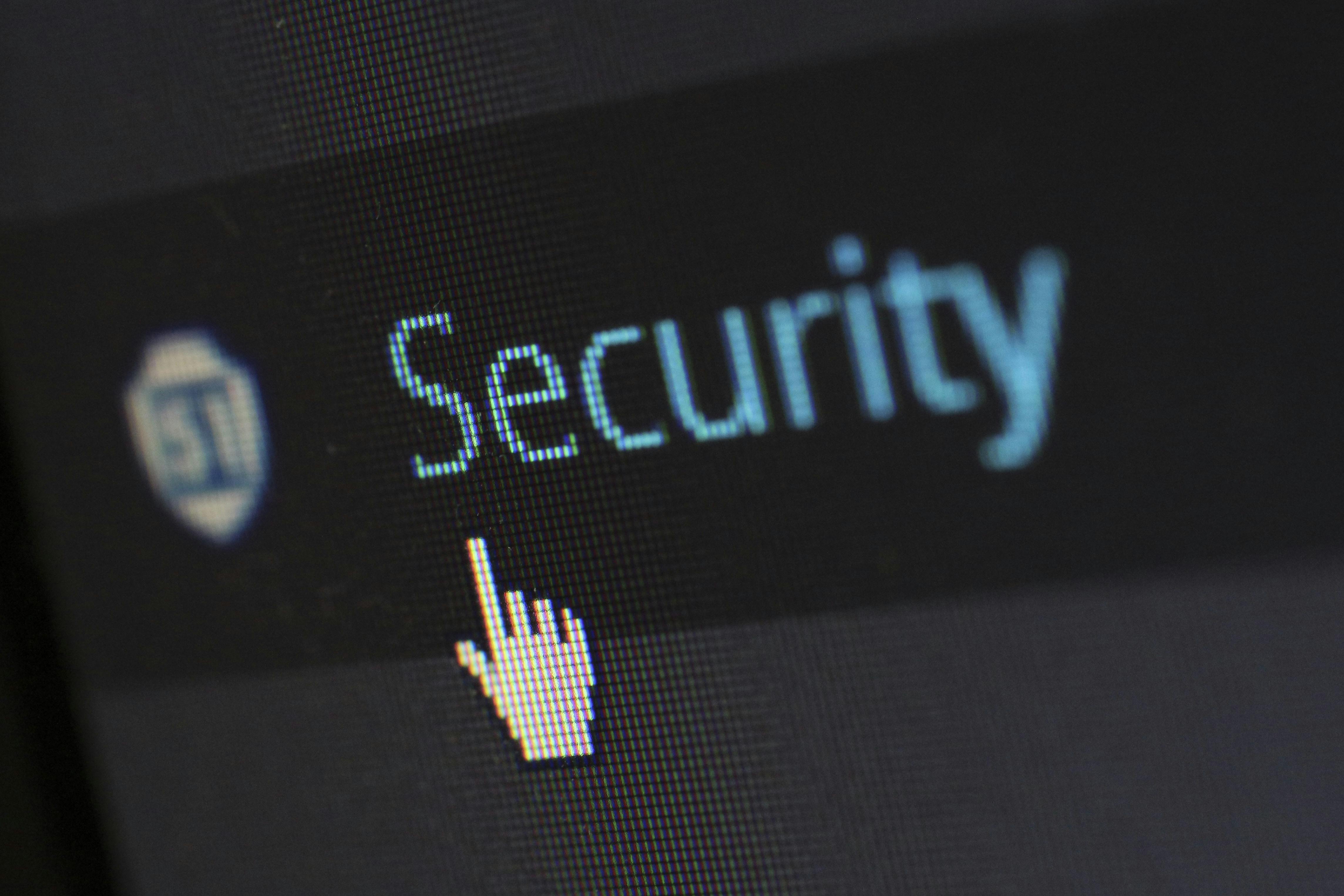 Computer screen showing the word security with a cursor icon, representing cybersecurity and data protection for insurance agencies.