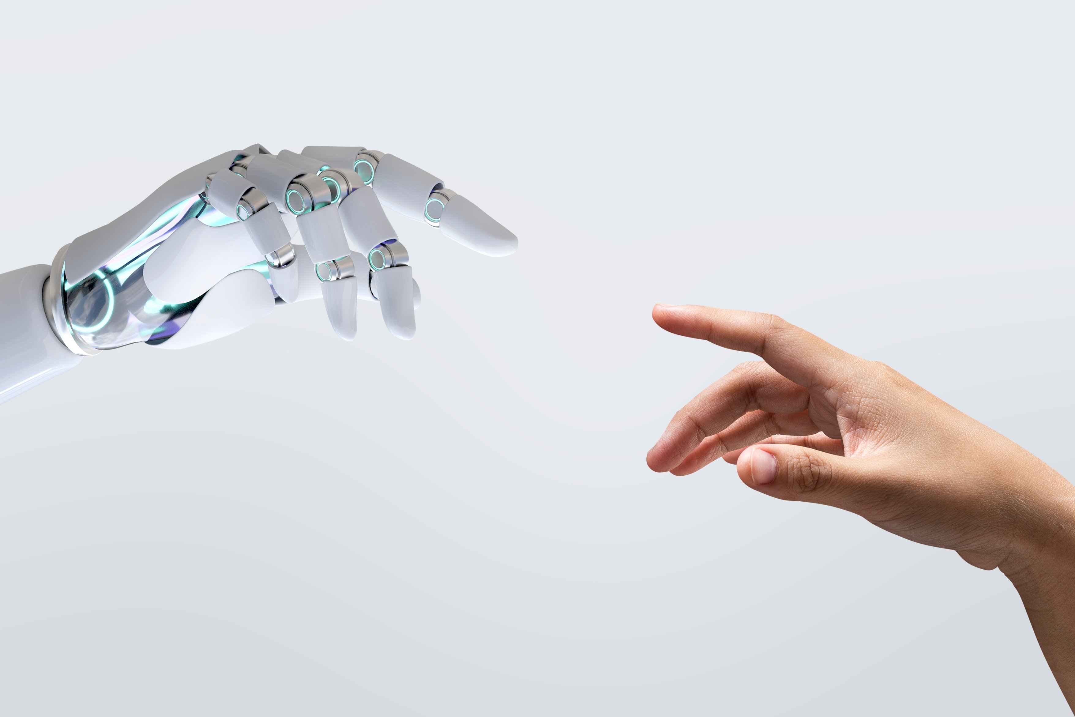 a human hand trying to reach a hand of a robot