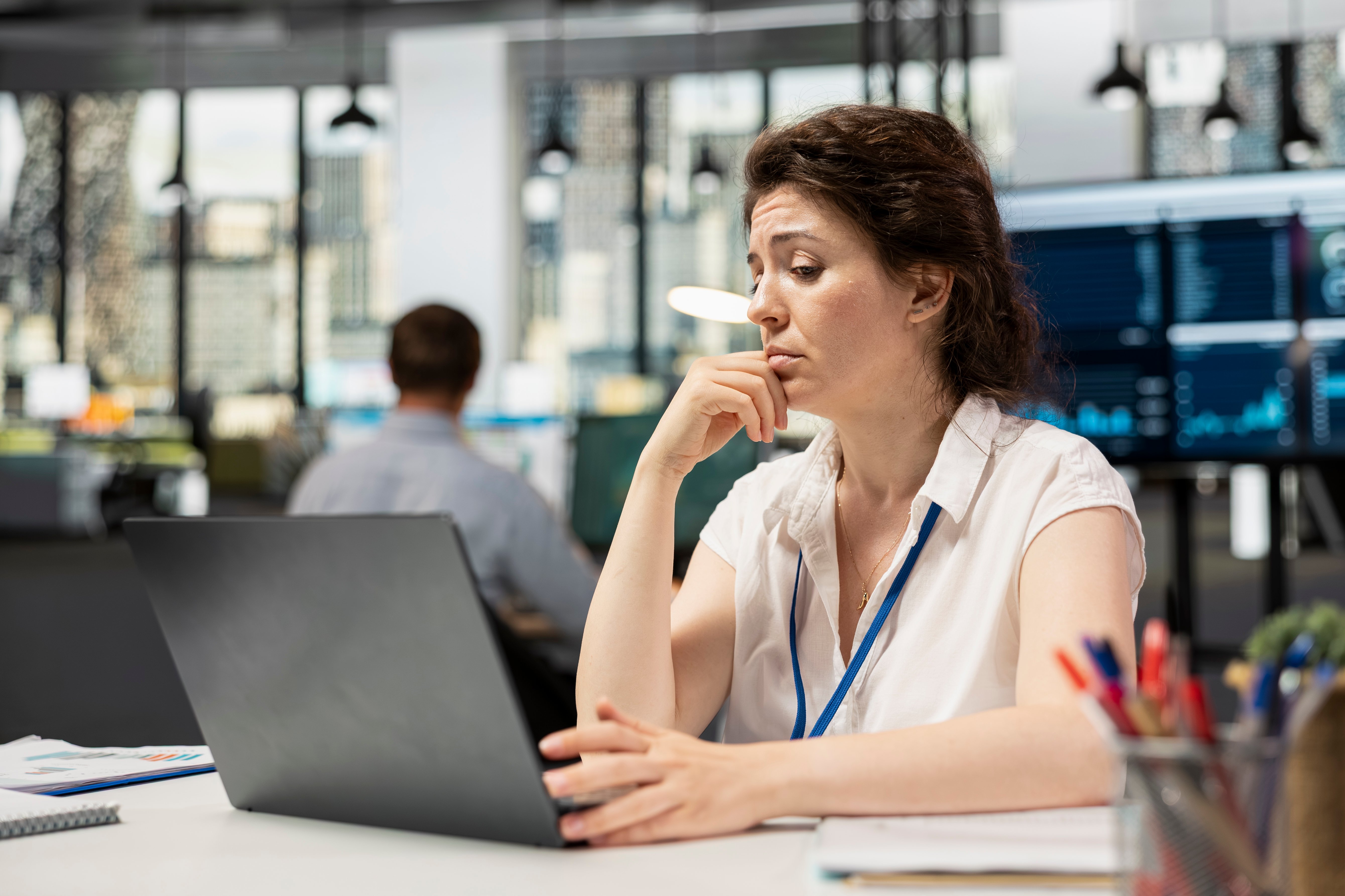 White female manager checking analytics on device analyzing financial data